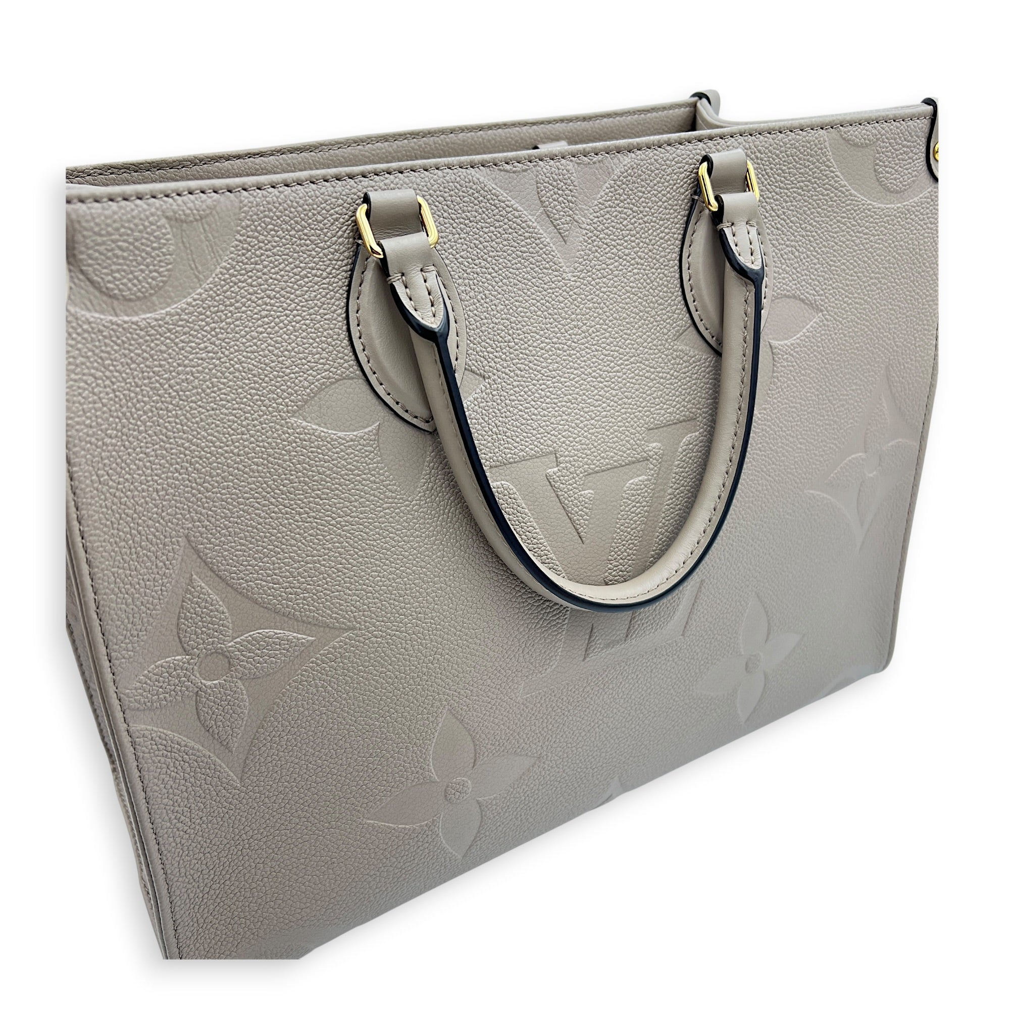 OnTheGo MM Beige Top Handle Bag in Empreinte Leather, Gold hardware
