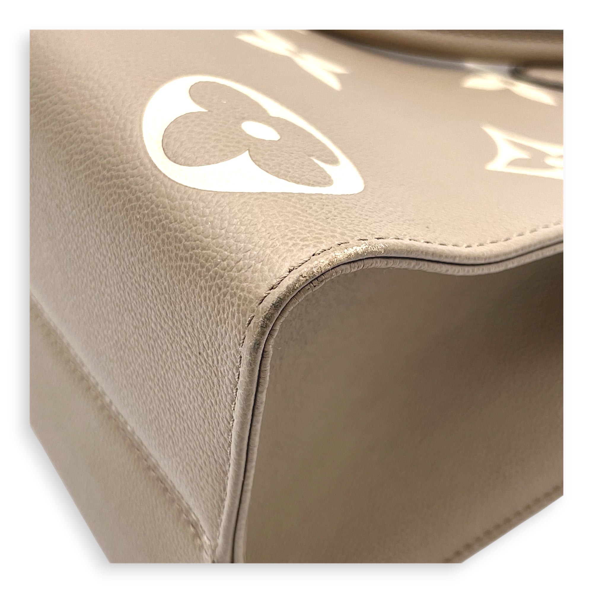OnTheGo Top Handle Bag MM Beige in Empreinte Leather, Gold hardware