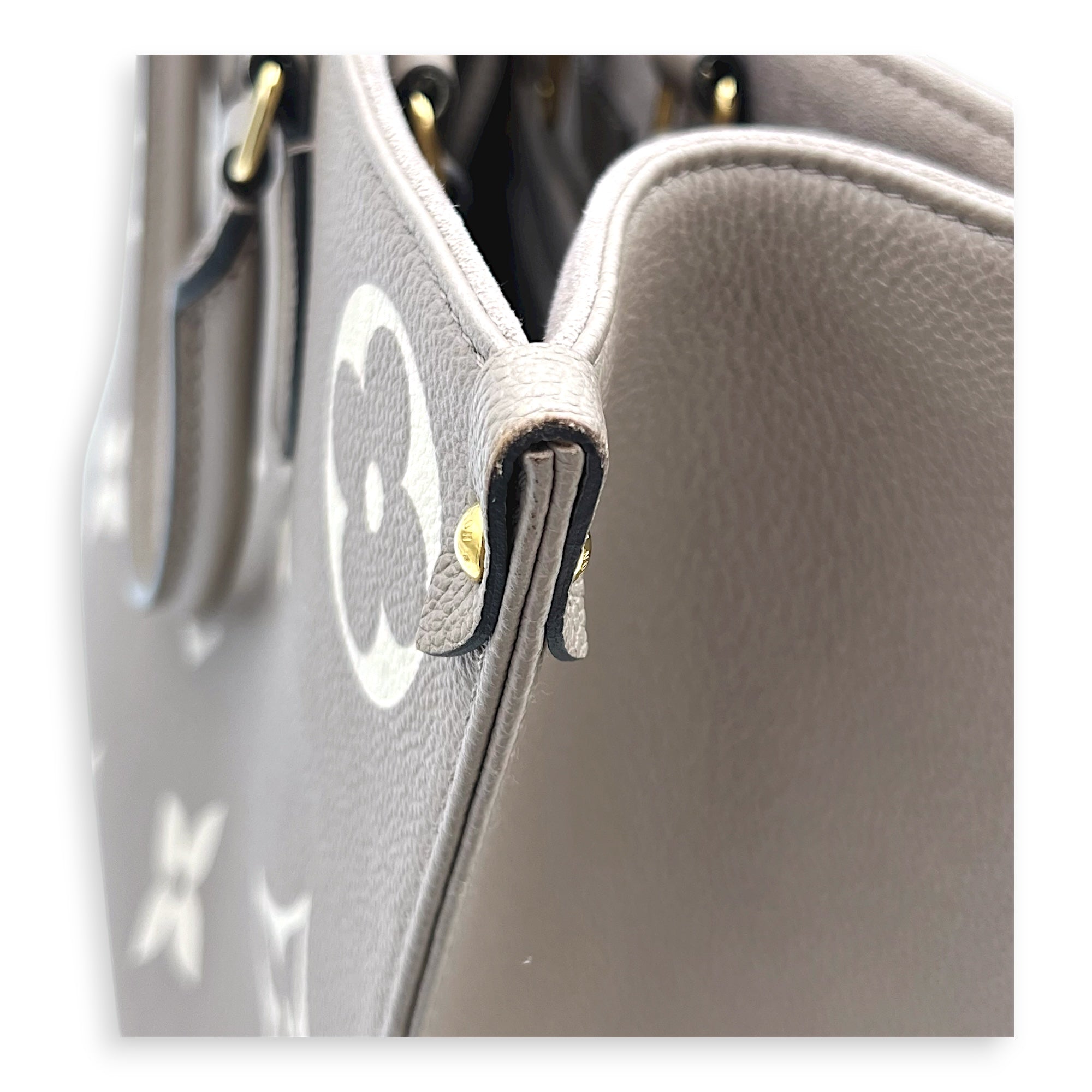 OnTheGo Top Handle Bag MM Beige in Monogram Empreinte Leather, Gold hardware