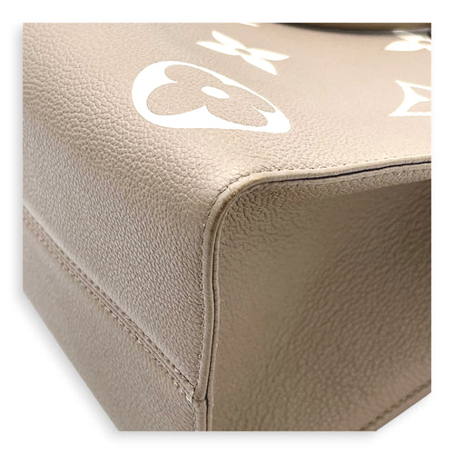 OnTheGo Top Handle Bag MM Beige in Monogram Empreinte Leather, Gold hardware