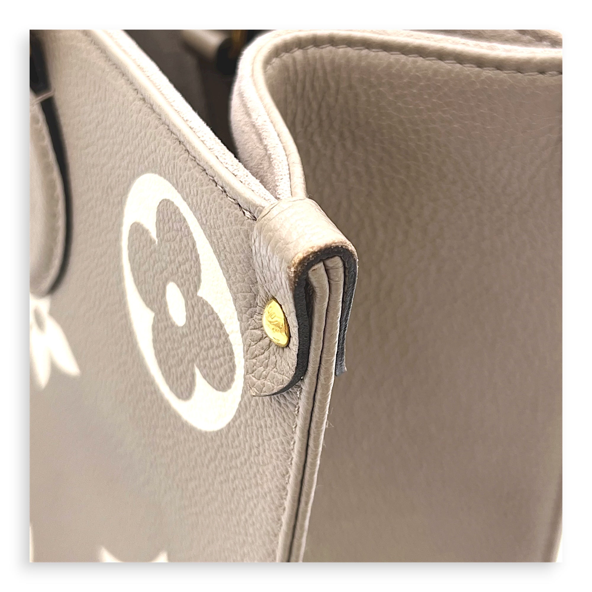 OnTheGo Top Handle Bag MM Beige in Monogram Empreinte Leather, Gold hardware