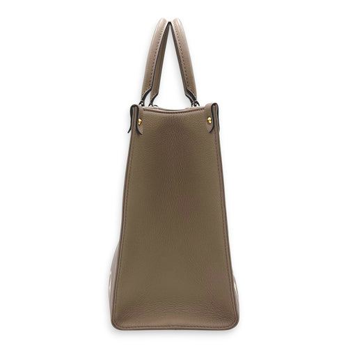 OnTheGo Top Handle Bag MM Beige in Monogram Empreinte Leather, Gold hardware