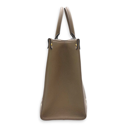 OnTheGo Top Handle Bag MM Beige in Monogram Empreinte Leather, Gold hardware