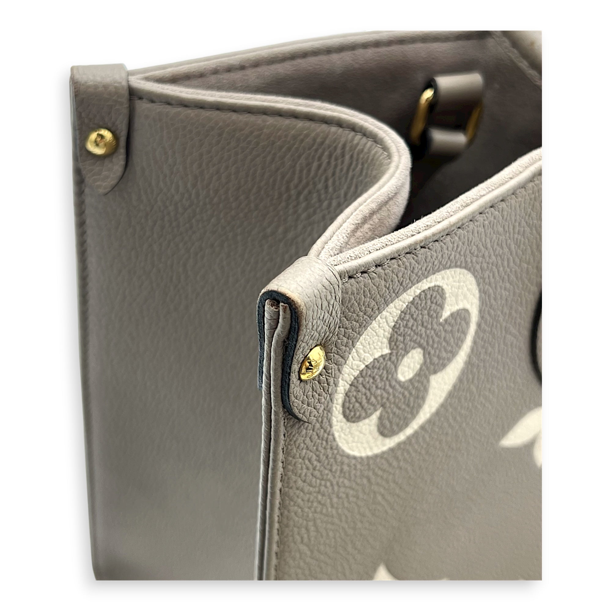 OnTheGo Top Handle Bag MM Beige in Monogram Empreinte Leather, Gold hardware