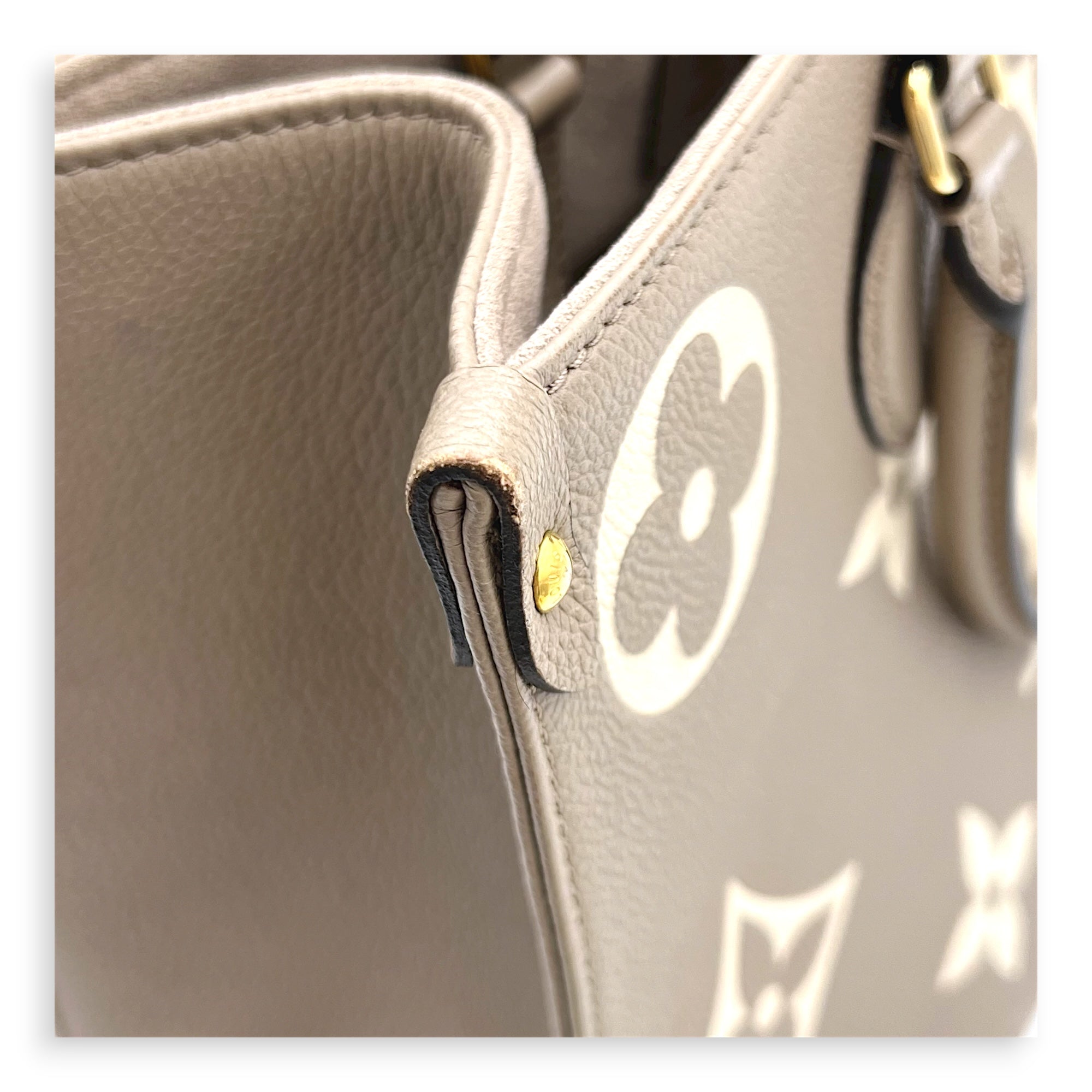 OnTheGo Top Handle Bag MM Beige in Monogram Empreinte Leather, Gold hardware