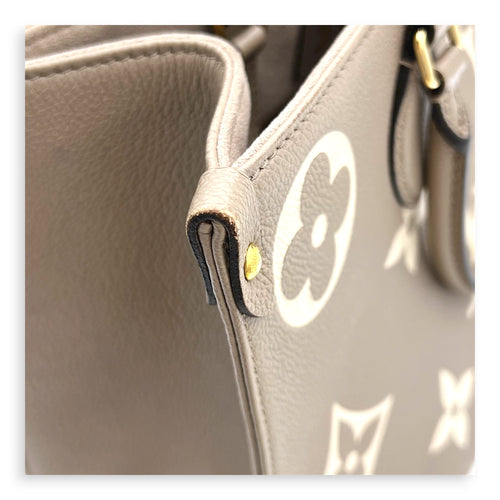 OnTheGo Top Handle Bag MM Beige in Monogram Empreinte Leather, Gold hardware