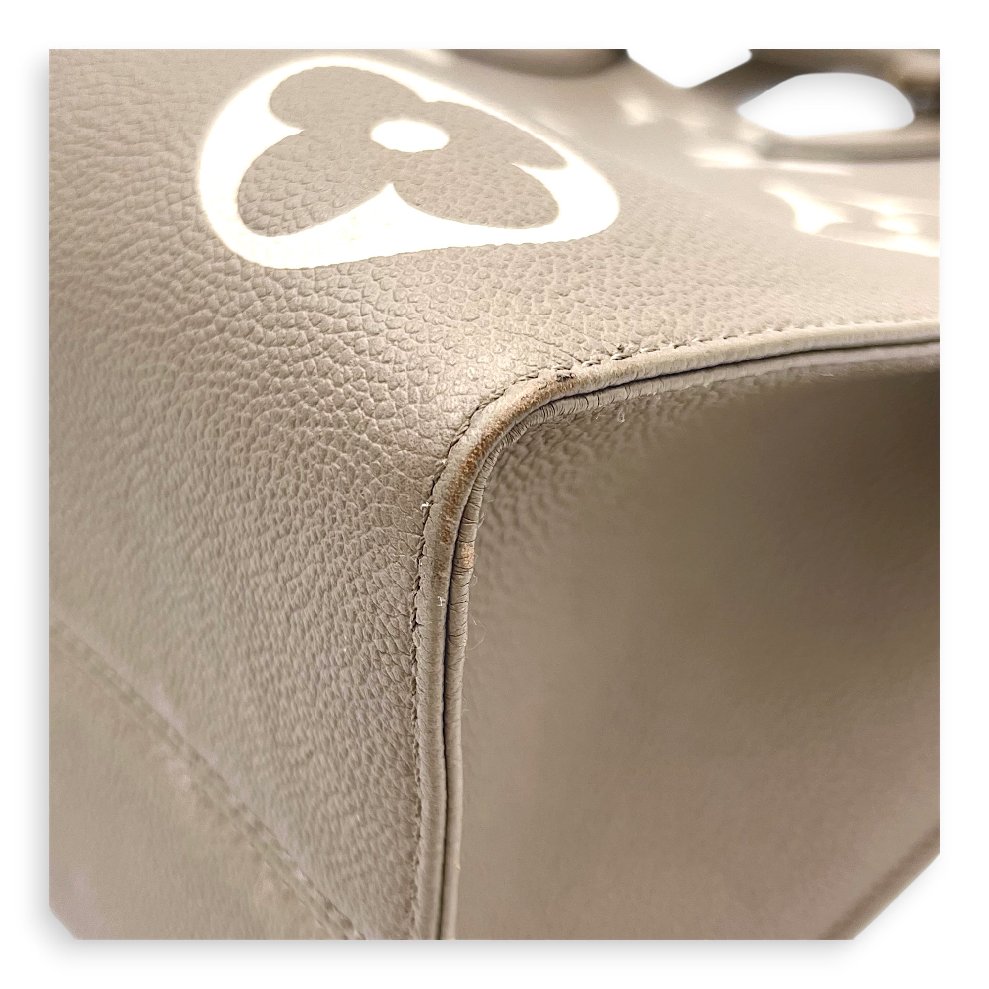 OnTheGo Top Handle Bag MM Beige in Monogram Empreinte Leather, Gold hardware