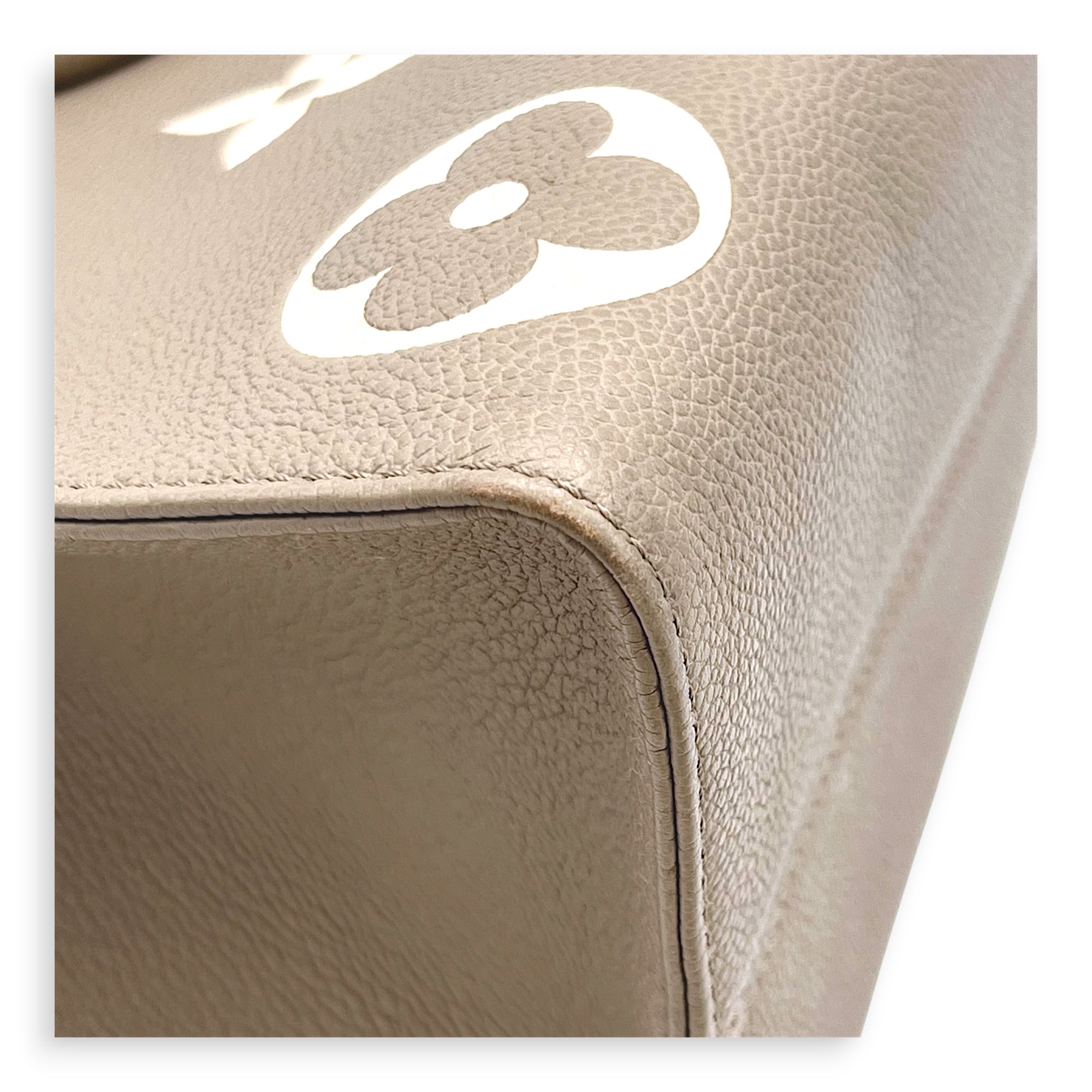 OnTheGo Top Handle Bag MM Beige in Monogram Empreinte Leather, Gold hardware