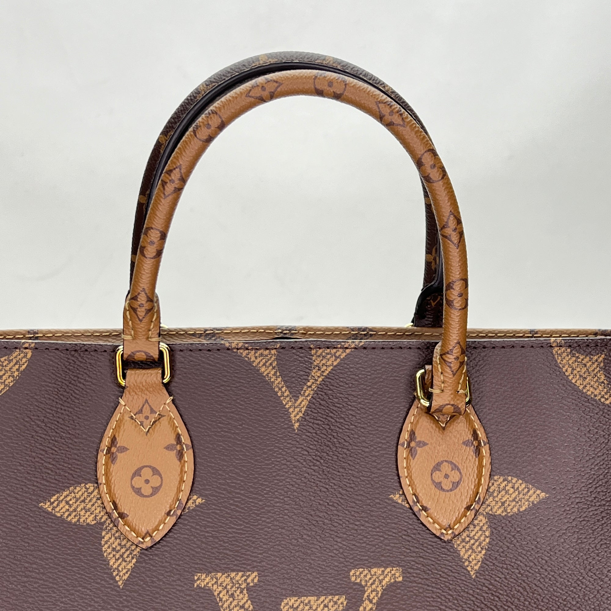 OnTheGo MM Brown Top Handle Bag in Monogram Coated Canvas, Gold hardware